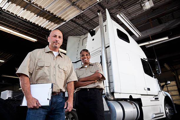 istock Workers in garage with semi-truck 171108877