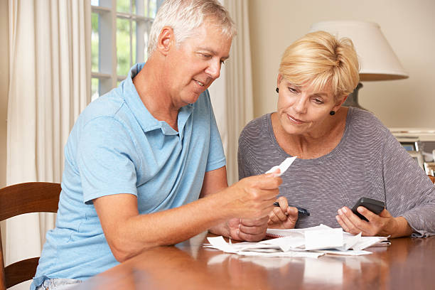 istock Mature Couple Checking Finances And Going Through Bills Together 171108900