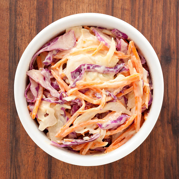 Coleslaw salad Top view of white bowl full of coleslaw salad coleslaw stock pictures, royalty-free photos & images