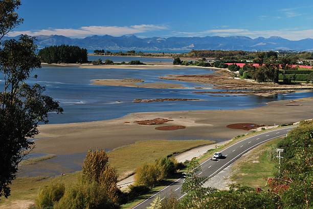 Road and Seascape, Riwaka Estuary, NZ  motueka stock pictures, royalty-free photos & images