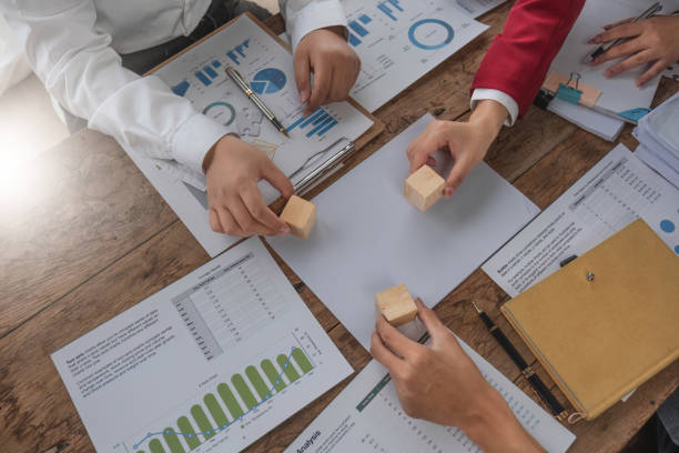 istock A group of business people assembling jigsaw puzzle. The concept of cooperation, teamwork, help and support in business. 1711105885