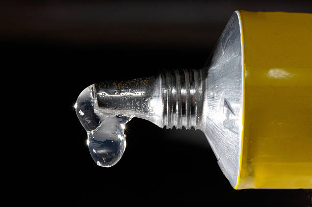 glue drops transparent glue against black background solvent stock pictures, royalty-free photos & images