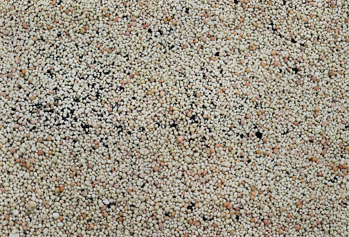 Pellets of ammonium nitrate flat lay with. Mineral fertilizer. granular mineral fertilizer, closeup top view. with black Mineral plant food dressing