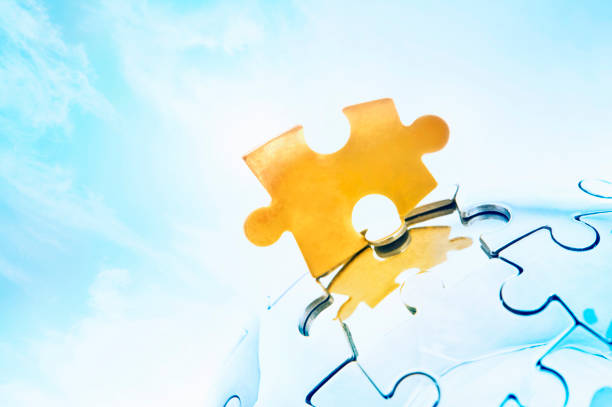 istock Golden jigsaw piece against bright sky 171111038