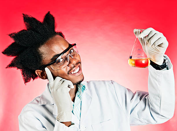 A geeky young male scientist with an Afro and wearing a lab coat and glasses smilingly shows us his discovery:  a lab flask containg a yellow liquid. Red background.