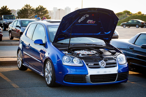 Dartmouth, Nova Scotia, Canada - May 24, 2012: A Volkswagen Golf R32 parked in a parking lot with hood up.  With the hood up, the 3.2L V6 engine is visible.  It produces 250HP, and 236lb-ft torque.  Some manufacturer decals are visible under the hood.  In addition other cars are visible in parking lot, with a Corvette C6 Z06 directly beside Volkswagen Golf.