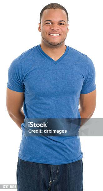 Smiling Young Man With Hands Behind Back Stock Photo - Download Image Now - Simplicity, T-Shirt, White Background