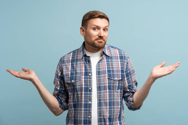 istock Man spreads hands to sides, not knowing answer, having no idea. Confused guy opened arms to sides 1711126748