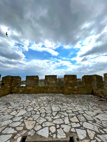 Battlement fortress wall with loopholes against the sky. High quality photo