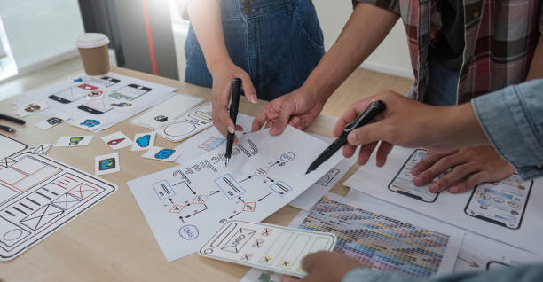 istock A smart and handsome young Asian male website developer is talking and planning a new project with a female colleague in the office. UI, UX, Tech Startup 1711133335