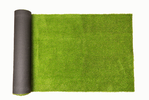 Top view of artificial rolled green grass, isolated on white background