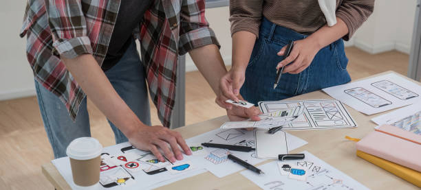 istock A smart and handsome young Asian male website developer is talking and planning a new project with a female colleague in the office. UI, UX, Tech Startup 1711137249