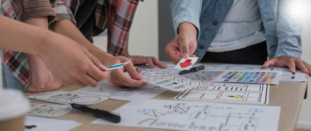 istock A smart and handsome young Asian male website developer is talking and planning a new project with a female colleague in the office. UI, UX, Tech Startup 1711137270