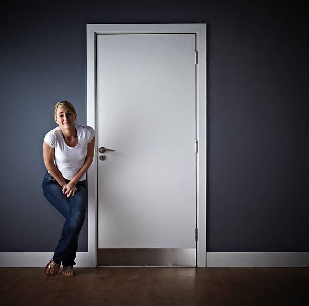Woman waiting outside ladies toilet Desperate for a wee! Woman waiting outside ladies toilet cross legged stock pictures, royalty-free photos & images