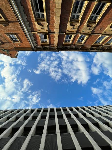 istock Tenement house and modern building against the sky 1711141081