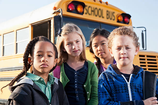 istock Children standing outside school bus 171114357