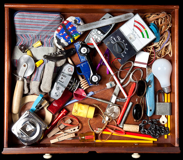 Junk in a drawer Drawer with many miscellaneous objects. tape measure photos stock pictures, royalty-free photos & images