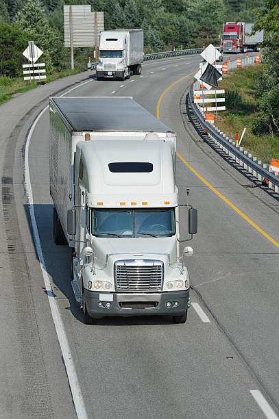 istock Trucks Moving on Highway, American Interstate in Evening Sunlight 171114527