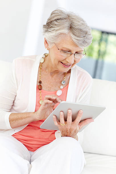 istock Bespectacled senior woman with tablet 171114766