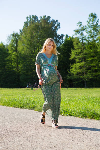 istock Young pregnant woman walking in a park 171114773