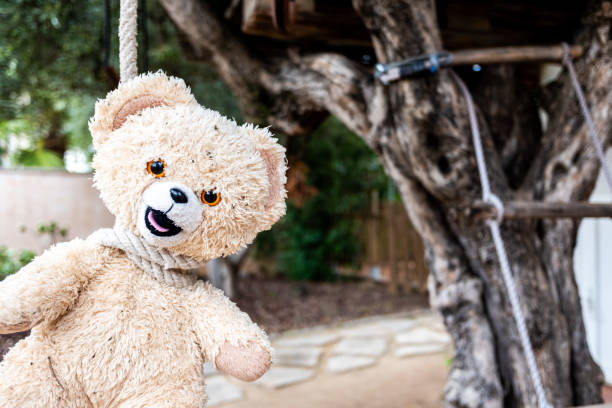 istock Strange and scary image, a teddy bear hanged with a neck rope. 1711148868