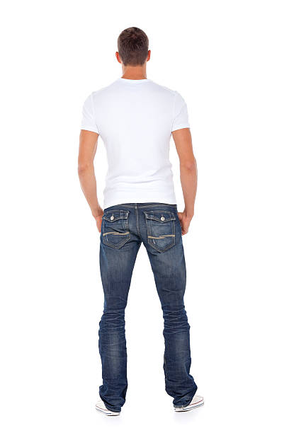 Rear View Of A Man Peeing On The Wall Of A Building
