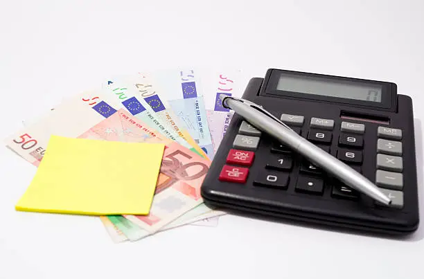 Money ,Calculator ,postil and Pen on white,Financial concept.