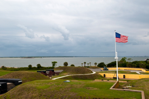 An 1809 American flag (15 stars and 15 stripes) flies over Fort Moultrie on Sullivan's Island, located at the entrance to Charleston Harbor in Charleston, South Carolina. For Sumter is visible across the water, on the left.More of my images from Charleston: