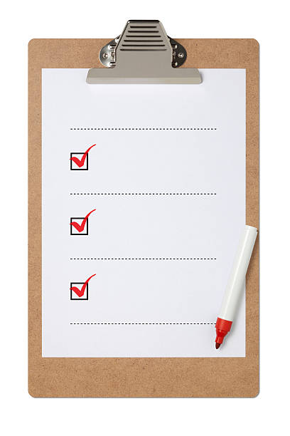 Blank checklist on clipboard with three red check marks stock photo