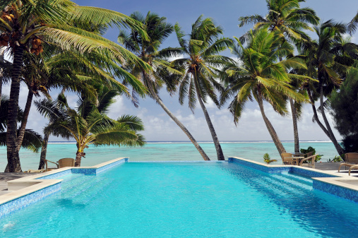 A turquoise infinity swimming pool overlooking a tropical lagoon