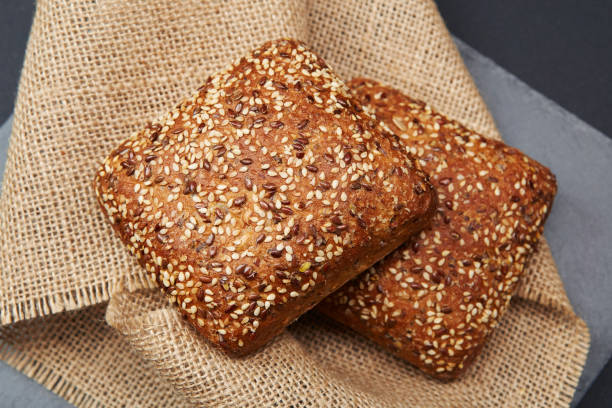 istock Freshly baked rustic bread buns with sesame seeds 1711167089