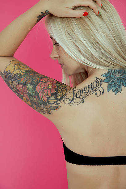 Woman with Tattoos Woman with Tattoos back shoulder tattoos for women pictures stock pictures, royalty-free photos & images