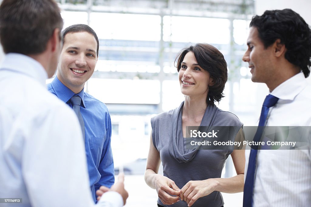 Enjoying a quick office get-together Group of businesspeople having a casual discussion in the office Business Stock Photo