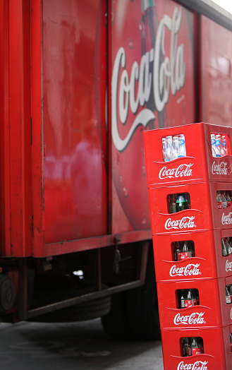 Madrid, Spain - April 27, 2012: Coke crate and bottles in Madrid, Espagna.Coca-Cola delivery truck in the background.