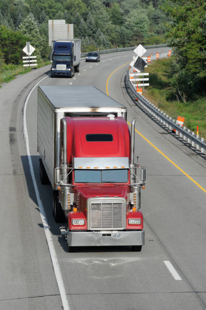 istock Trucks Moving on Highway, American Interstate in Evening Sunlight 171116990