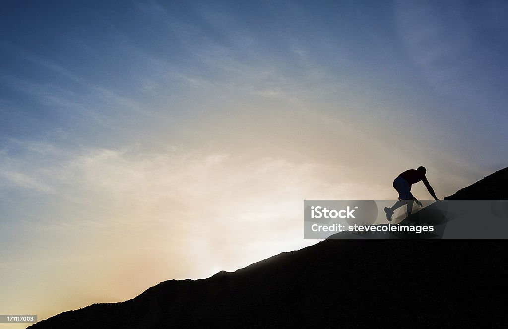 Mountain Climbing A man climbing up a mountain. On Top Of Stock Photo