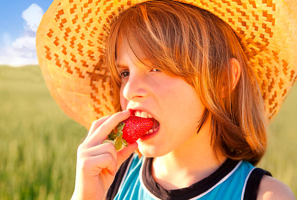 istock Little boy eating strawberry 171117088