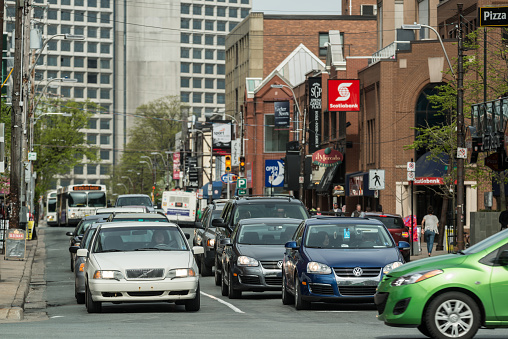 Halifax, Canada - May 15, 2012: Rush hour traffic waits at the intersection of Spring Garden Road and South Park Street opposite the Public Gardens just outside the city's downtown core.