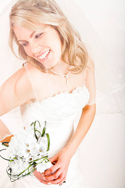 istock Smiling bride holding white bouquet 171117177