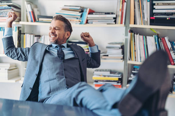 istock Middle aged businessman stretching his back and arms after taking a break 1711173505