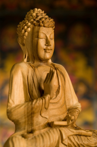 Wooden Statue of Budhha . It looks like a shrine in a temple. .