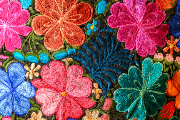 istock Background of hand-embroidered flowers on a fabric with colored threads. 1711176171
