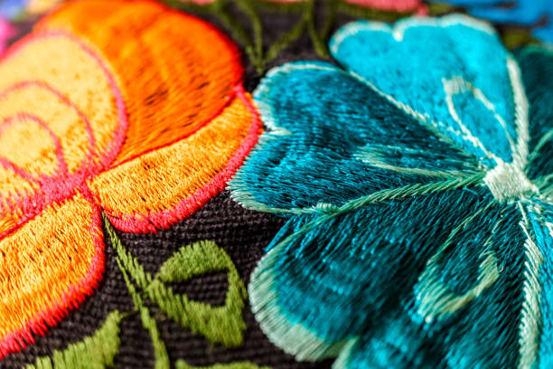 istock Background of hand-embroidered flowers on a fabric with colored threads. 1711177110