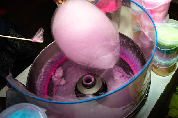istock Machine to make cotton candy by turning and toasting the pink sugar. 1711181003