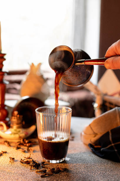 istock Pouring Turkish coffee into a glass, composition in warm colors 1711181565