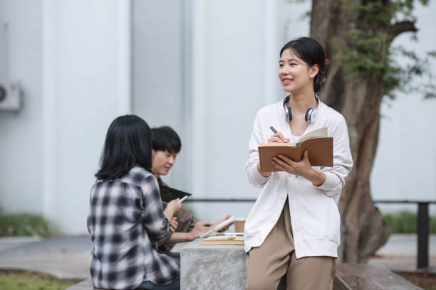 istock Students asian portrait together smiling group reading book study with laptop at university high school campus,college in summer holiday relaxation 1711182605