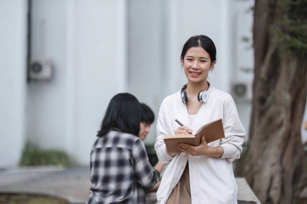 istock Students asian portrait together smiling group reading book study with laptop at university high school campus,college in summer holiday relaxation 1711182612