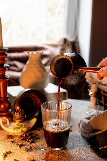 istock Pouring Turkish coffee into a glass, composition in warm colors 1711183137