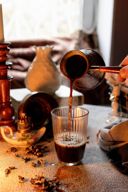 istock Pouring Turkish coffee into a glass, composition in warm colors 1711183139