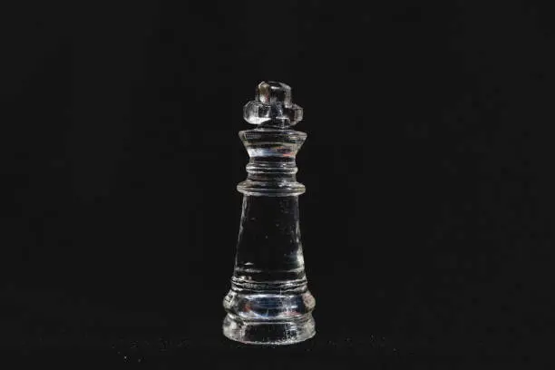 Piece of transparent chess,king,  black background